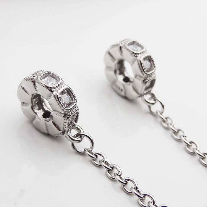 DIJE CADENA DE SEGURIDAD PIEDRAS PLATA.925